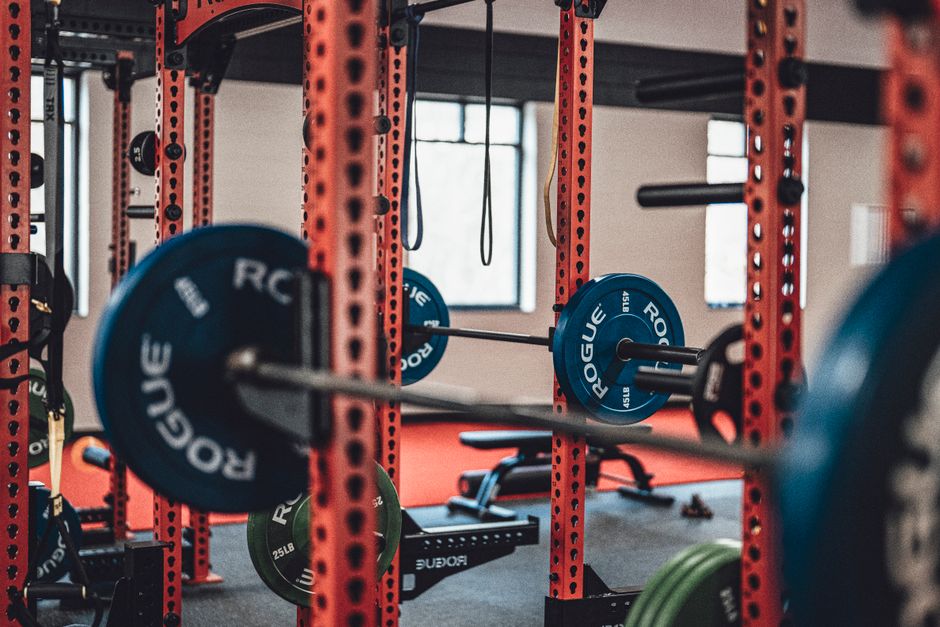 Close-up view of gym equipment with barbells and weight plates, perfect for strength training enthusiasts.